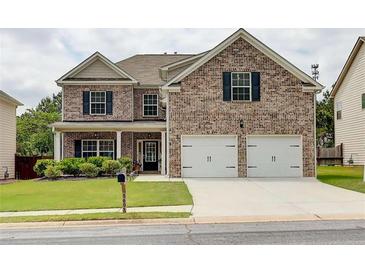 Beautiful two-story brick home featuring a two-car garage and a well-maintained front yard at 5601 Savannah River Rd, Atlanta, GA 30349