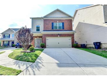 Inviting two-story home featuring a well-manicured lawn and a convenient two-car garage at 3128 Onamia Rd, Duluth, GA 30096