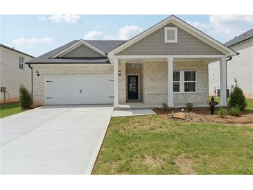 Charming single-story home featuring a two-car garage and a welcoming front porch at 7760 Sheffield Ter, Fairburn, GA 30213