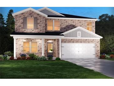 Beautiful two-story brick home featuring a manicured lawn, two-car garage, and inviting covered front entry at 7761 Halifax Way, Fairburn, GA 30213