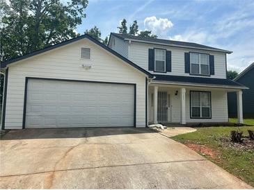 Charming two-story home features a two-car garage and a welcoming front porch with classic columns at 1247 To Lani Farm Rd, Stone Mountain, GA 30083