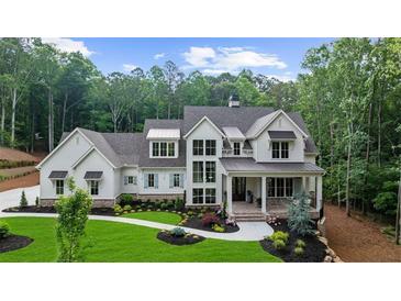 Stunning two-story home featuring elegant white siding, black accents, and a professionally landscaped front yard at 1084 Wrights Mill Rd, Canton, GA 30115