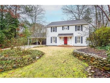 Charming two-story home featuring black shutters and a vibrant red front door at 970 Winding Creek Trl, Sandy Springs, GA 30328