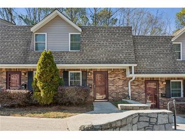 Traditional brick townhome with well-maintained landscaping and charming front entryway at 3135 Reeves Se St, Smyrna, GA 30080