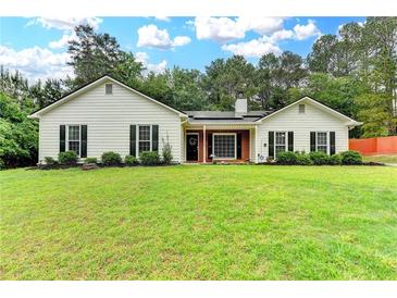 Charming single-story home with a well-maintained lawn and mature trees at 425 Charlyne Way, Dacula, GA 30019