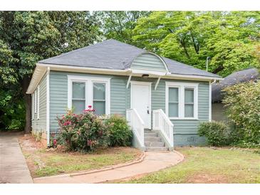 Charming cottage-style home featuring a well-manicured lawn and inviting front porch at 2497 Lakewood Sw Ave, Atlanta, GA 30315