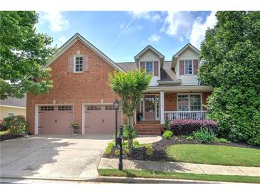 Charming brick home featuring a two-car garage and well-maintained landscaping at 116 Patrick Way, Marietta, GA 30064