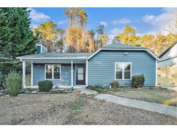 Charming single-story home with blue siding, a covered front porch, and a landscaped front yard at 3918 S Creek Ct, Stone Mountain, GA 30083