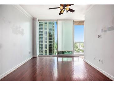 Bright living room features hardwood floors and floor-to-ceiling windows with a city view at 361 17Th Nw St # 2407, Atlanta, GA 30363