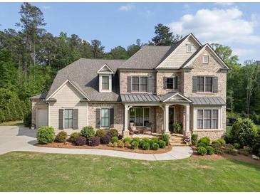 Elegant two-story brick home with a covered front porch and meticulously landscaped front yard at 3024 Malbec Vly, Acworth, GA 30101