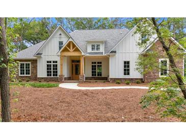 Charming new construction home with stone accents, wood porch, and manicured landscaping at 11 Headden Nw Rdg, Cartersville, GA 30121