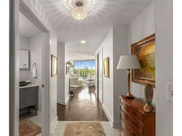 Bright hallway featuring hardwood floors, elegant lighting, and seamless transition to the living area with a stunning view at 700 Park Regency Ne Pl # 1407, Atlanta, GA 30326