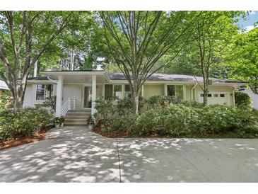 Charming ranch home with mature landscaping and a welcoming front entrance at 1410 Lively Ridge Ne Rd, Atlanta, GA 30329