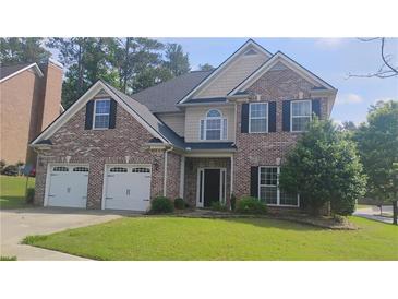 Charming two-story brick home features a two-car garage and well-manicured lawn at 1481 Park Knoll Trl, Lawrenceville, GA 30043
