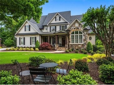 Charming home with stone and siding, a manicured lawn and established landscaping at 3013 Walker Hill Way, Marietta, GA 30064