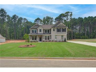 Beautiful new construction home featuring a manicured lawn and a mix of stone and siding exterior at 100 Bree Dr, Fayetteville, GA 30214