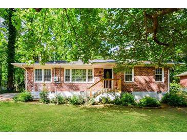 Charming brick home featuring a well-manicured lawn and a welcoming wood porch at 3697 Wisteria Sw Ln, Atlanta, GA 30331