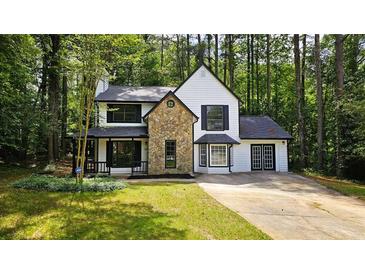 Charming two-story home featuring a stone accent facade and white siding at 381 Fleming Ct, Jonesboro, GA 30238