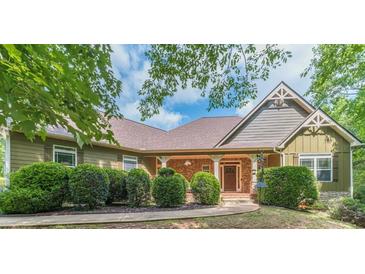 Charming single-Gathering home with a covered porch, brick accents, and well-manicured landscaping at 255 Nicklaus Cir, Social Circle, GA 30025