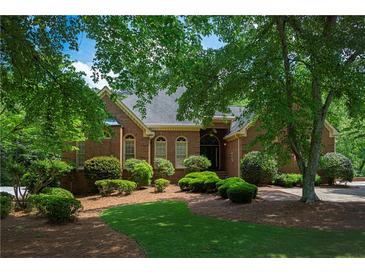 Charming brick home with manicured landscaping and mature trees offers great curb appeal at 1187 Ward Creek Sw Dr, Marietta, GA 30064