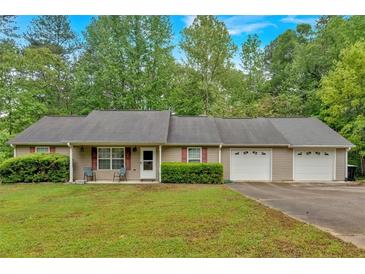 Ranch-style home featuring a front porch and an attached two-car garage, set on a lush green lot at 161 Gann Cemetery Rd, Dallas, GA 30157