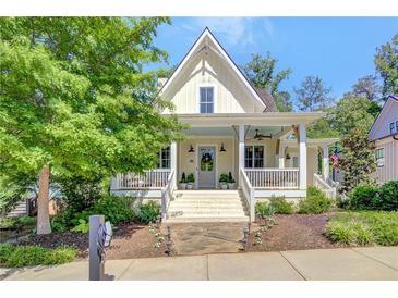Charming two-story home with a welcoming front porch and manicured landscaping at 11190 Serenbe Ln, Chattahoochee Hills, GA 30268