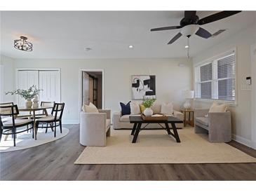Bright living room with hardwood floors, neutral furniture and a ceiling fan at 2222 Hill Nw St, Atlanta, GA 30318