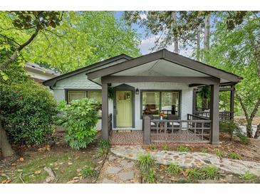 Charming cottage-style home with a covered porch and brick walkway at 901 United Se Ave, Atlanta, GA 30316