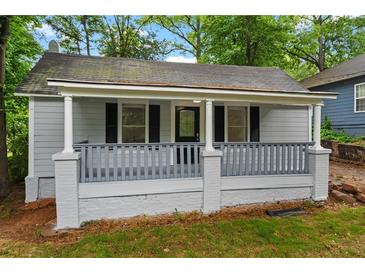 Charming single-story home with a cozy covered porch and freshly painted light gray siding at 1939 Dunlap Ave, Atlanta, GA 30344