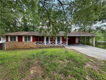 Charming one-story home featuring a brick foundation and a covered carport for convenient parking at 2184 River Acres Ct, Lithonia, GA 30058