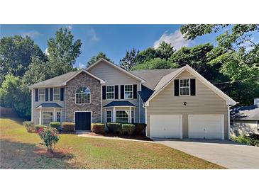 Charming two-story home with a stone accent, attached two-car garage, and a well-maintained lawn at 5368 Knights Lndg, Ellenwood, GA 30294