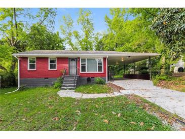 Cozy, red brick single story home featuring a large covered carport and landscaped front yard at 823 Catherine St, Forest Park, GA 30297