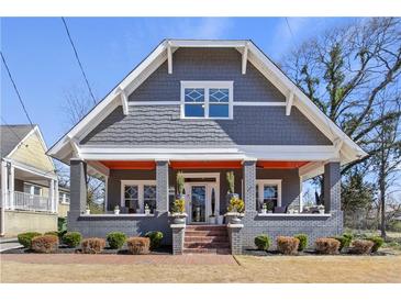 Charming craftsman-style home featuring a welcoming front porch and landscaped front yard at 1402 Sw Belmont Sw Ave, Atlanta, GA 30310