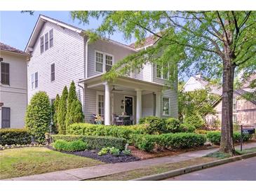 Charming two-story home features a covered porch with manicured landscaping at 6575 Eli Davis Rd, Cumming, GA 30040