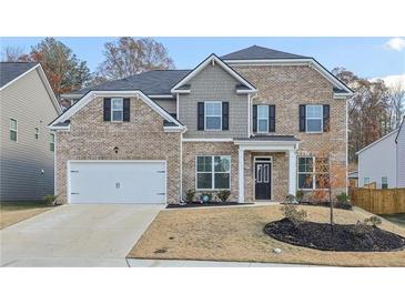 Charming two-story brick home with a two-car garage and well-manicured front yard at 1147 Trident Maple Chase, Lawrenceville, GA 30045