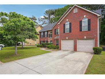 Charming two-story brick home with a two-car garage and a well-maintained front yard at 9744 Musket Ridge Cir, Jonesboro, GA 30238
