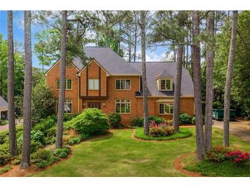 Charming brick home with a well-manicured lawn and mature trees in a desirable neighborhood at 3358 Stovehill Se Ct, Marietta, GA 30067