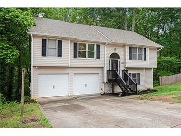 Charming two-story home featuring a two-car garage and welcoming front porch at 5174 Ridge Tarn, Acworth, GA 30102