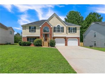 Inviting two-story home with a well-manicured lawn and two-car garage at 5452 Sweetsprings, Powder Springs, GA 30127