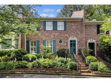 Charming brick townhouse with green shutters and meticulously landscaped front yard at 1534 September Chase, Decatur, GA 30033