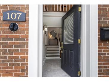 Inviting entryway featuring a black front door with glass and a glimpse of the home's interior at 1634 Ponce De Leon Ave # 107, Atlanta, GA 30307