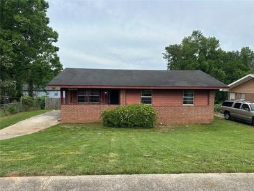 Charming single-story home featuring a brick facade, cozy porch, and well-maintained lawn at 4009 Ester Sw Dr, Atlanta, GA 30331
