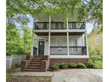 Charming two-story home featuring double balconies and brick-based front porch at 59 Stafford Nw St, Atlanta, GA 30314