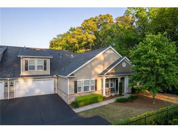 Charming townhome showcasing neat landscaping, attached garage, and inviting curb appeal at 2623 Grapevine Cir # 602, Cumming, GA 30041