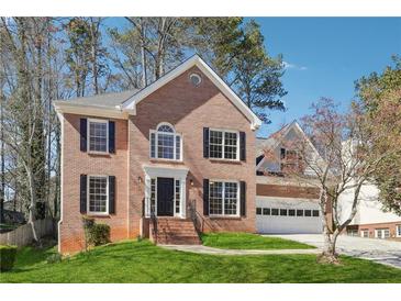 Charming two-story brick home with a well-manicured lawn and a two-car garage at 4271 Weston Sw Dr, Lilburn, GA 30047