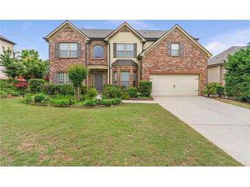 Charming two-story brick home with a well-manicured lawn and inviting curb appeal at 1645 Colleens Cask Ter, Dacula, GA 30019