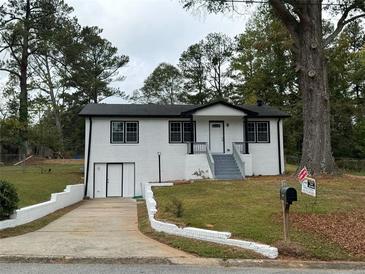 Charming renovated home with painted brick, inviting entryway, and well-maintained front yard at 3078 Michael Sw Dr, Marietta, GA 30060