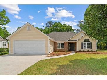 Charming single-story home featuring a two car garage, welcoming entrance, and well-maintained lawn at 102 Pine Bark Dr, Villa Rica, GA 30180
