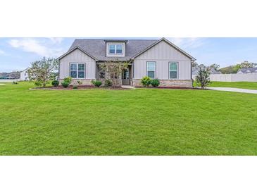 Charming single-story home featuring a beautifully landscaped front yard and classic architectural details at 112 Leveret Rd, Locust Grove, GA 30248