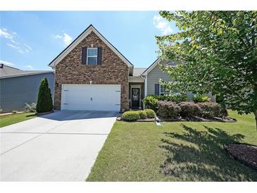 Charming home featuring a brick facade, manicured lawn, and a two-car garage at 2209 Cedar Place Ct, Snellville, GA 30078